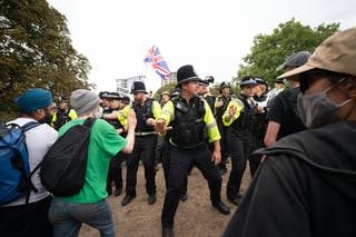 Police officers are deployed during a protest by Abolish Asylum System and counter demonstrators at Castle Park in Bristol